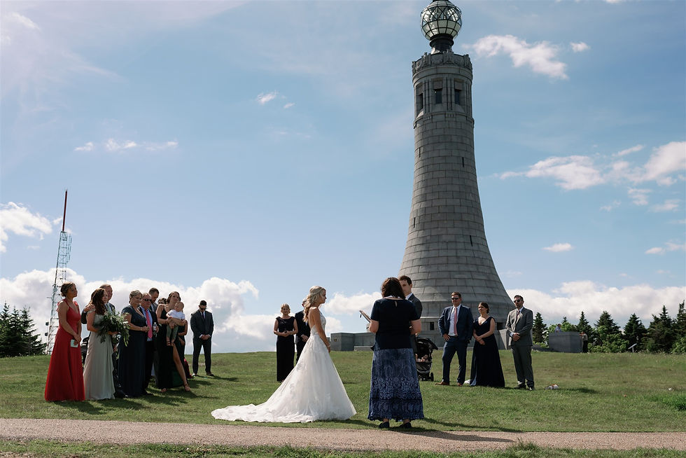 wedding ceremony with war memorial in the background on mount greylock