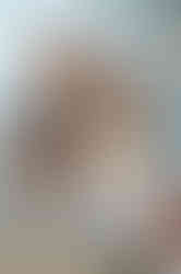 couple snuggling next to boston harbor with champagne