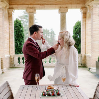 Couple feeding each other desserts on wedding day