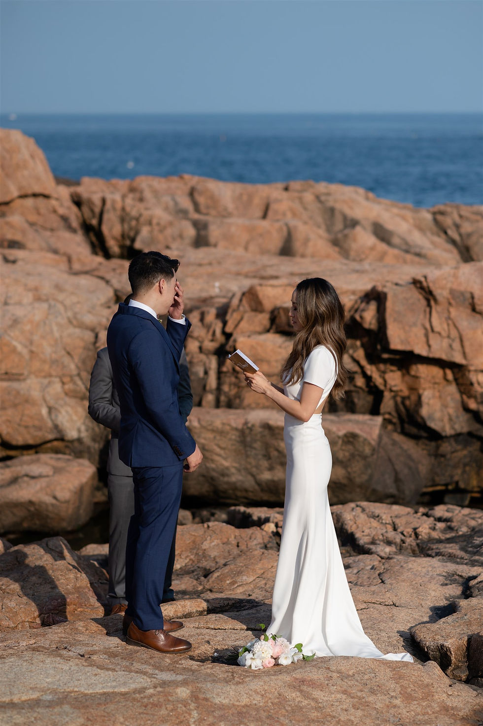 bride saying vows while groom wipes a tear