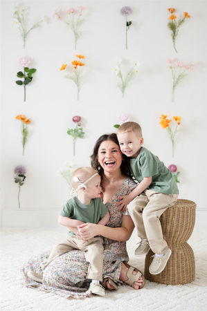 motherhood photoshoot with silk single stem flowers in central Massachusetts natural light photo studio