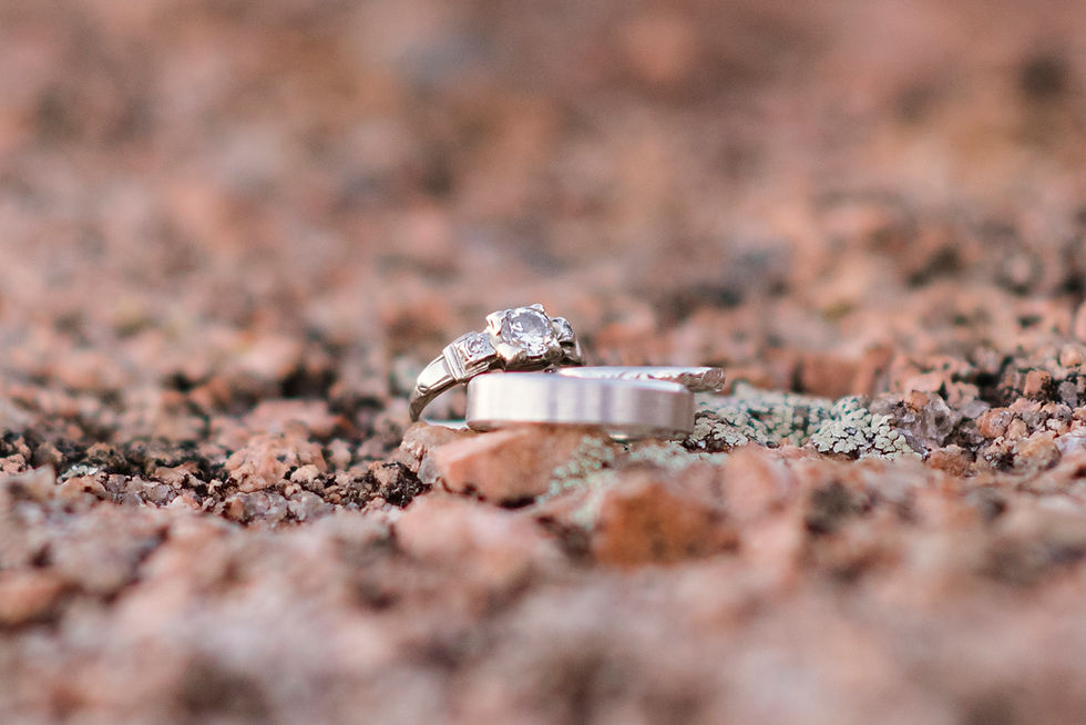 macro photo of wedding rings on pink granite at enchanted rock