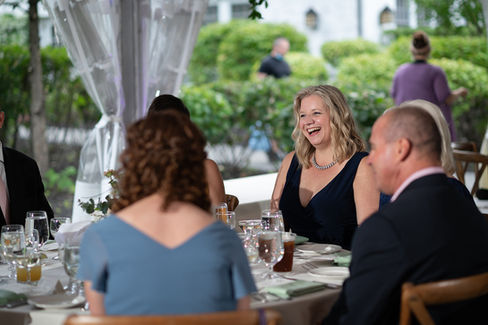 candid photo of guests laughing during wedding reception