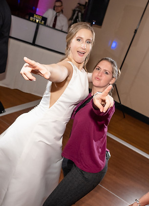 photographer and bride on the dance floor pointing at the camera