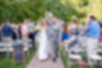 bride and groom celebrate walking down aisle after wedding ceremony