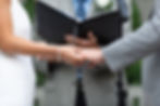 close up shot of hands during ring exchange at wedding ceremony