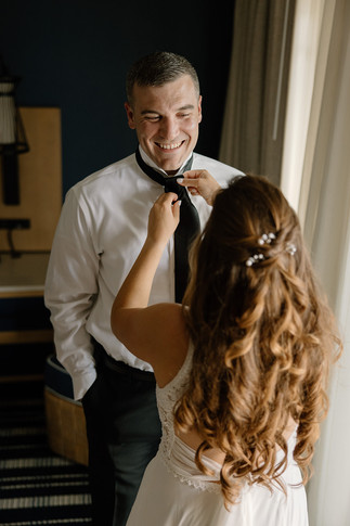 bride tying groom's tie