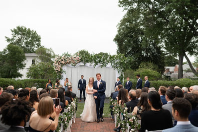 couple walking back down the aisle after inn on boltwood wedding ceremony 