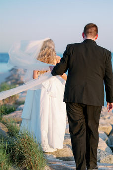 newlywed photos on jetty at beach at red jacket resort in cape cod