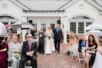 bride walking down aisle with parents