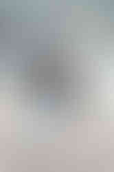 couple walking along harborwalk in boston seaport for engagement session