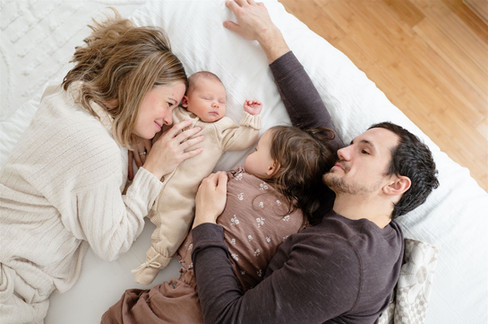 family photo laying on bed