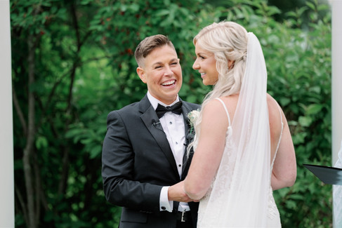 partners laughing during wedding ceremony