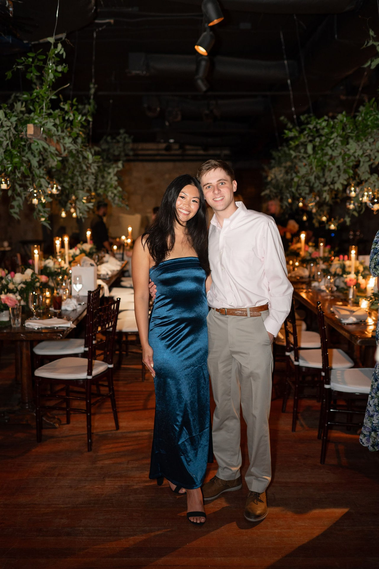 couple posing for photo in "the cave" at omni mount washington resort during rehearsal dinner