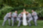 bride and groomsmen doing finger guns at the camera