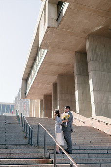 couple on the steps of building for urban elopement