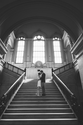 black and white photo of couple on grand staircase
