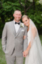 bride and groom smile at camera