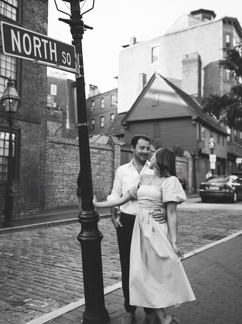 couple swings on light post in north end boston