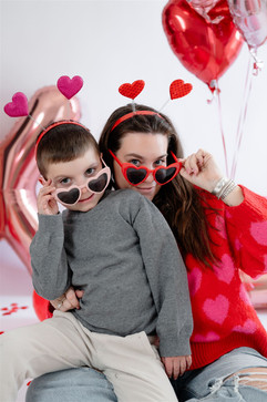 mommy and son peeking at the camera over glasses