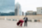 a couple in formal attire on the roof of a parking garage in downtown austin texas for their engagement photos