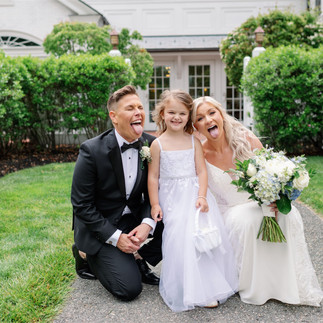 brides playing with flower girl