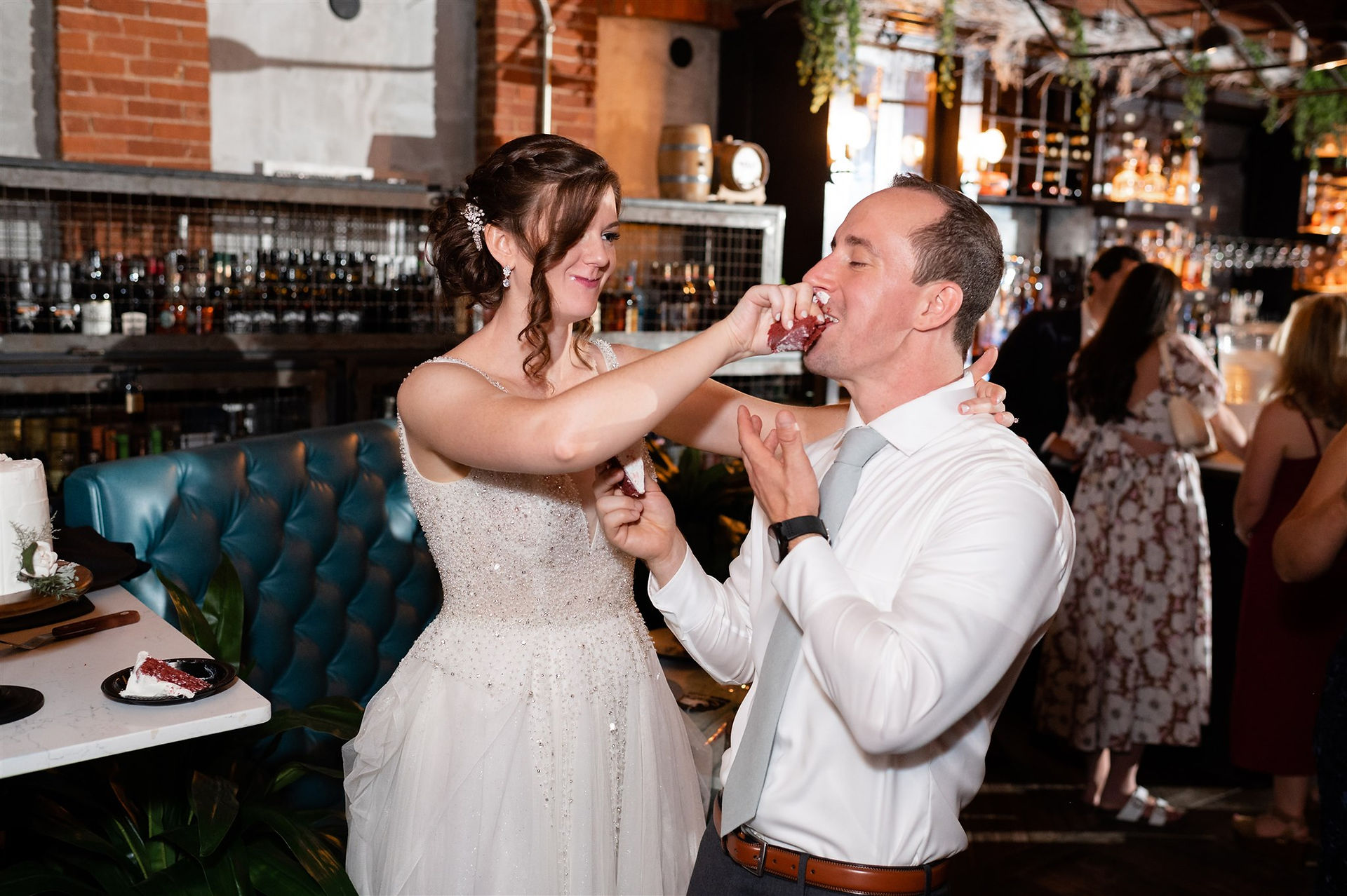bride shoving cake in groom's face