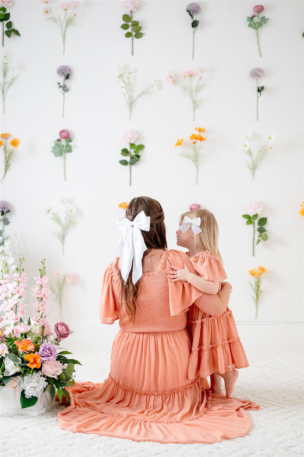 motherhood photoshoot with silk single stem flowers in central Massachusetts natural light photo studio