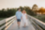 summer engagement session at Salisbury Beach in Salisbury, Massachusetts couple walking on boardwalk