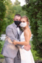 bride and groom pose in masks during COIVD-19 wedding