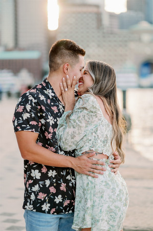 couple smiling at each other for engagement session