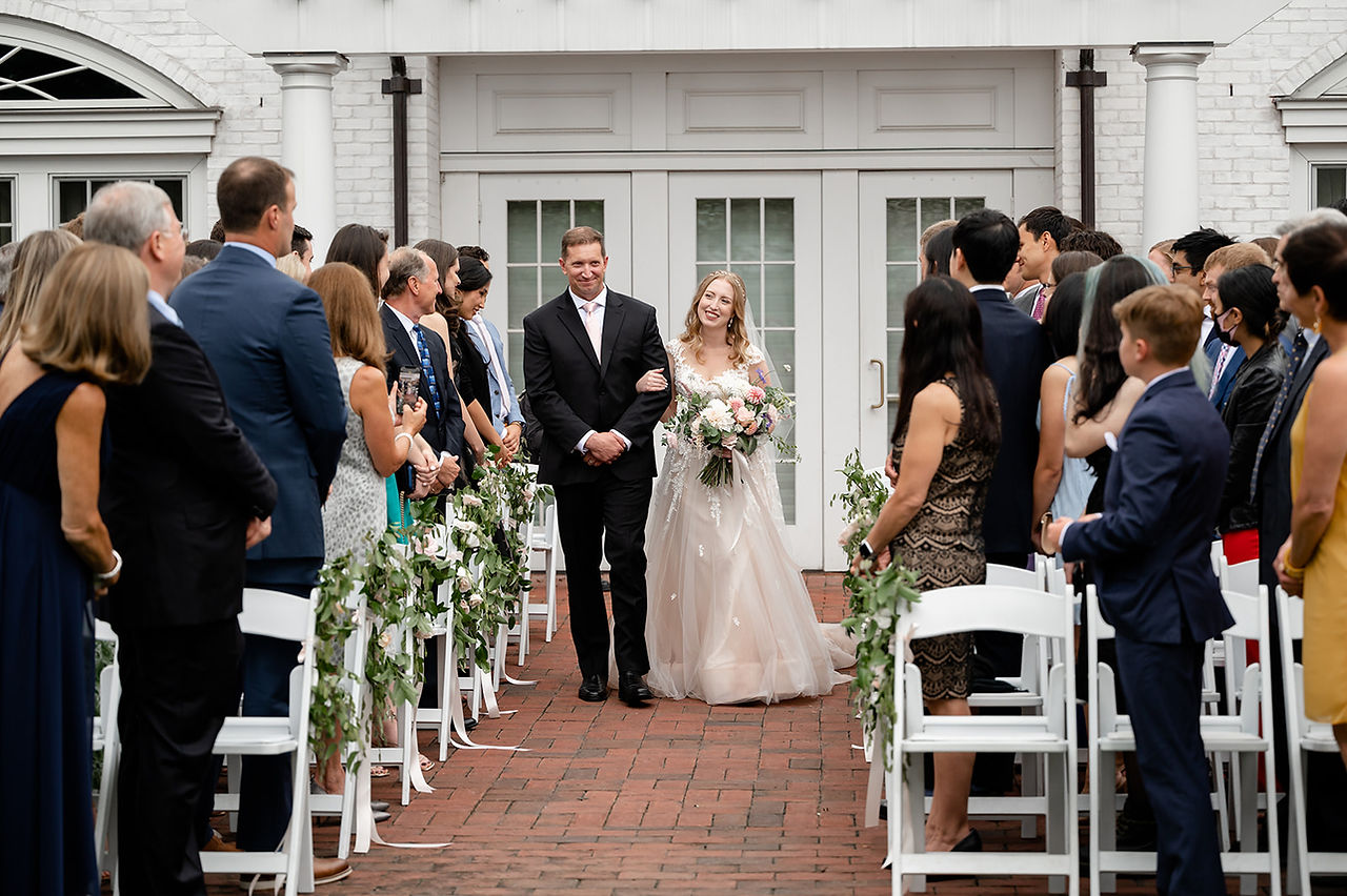 groom walking bride down aisle at inn on boltwood
