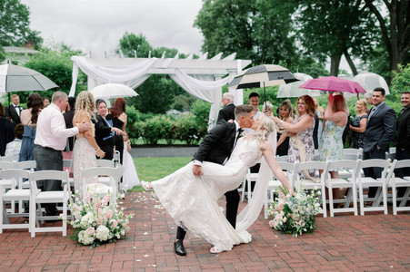 couple doing a dip kiss in aisle after wedding ceremony for a must-have ceremony photo