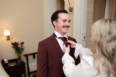 bride tying groom's tie