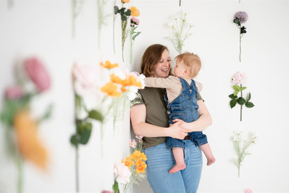 mommy and son playing with flowers