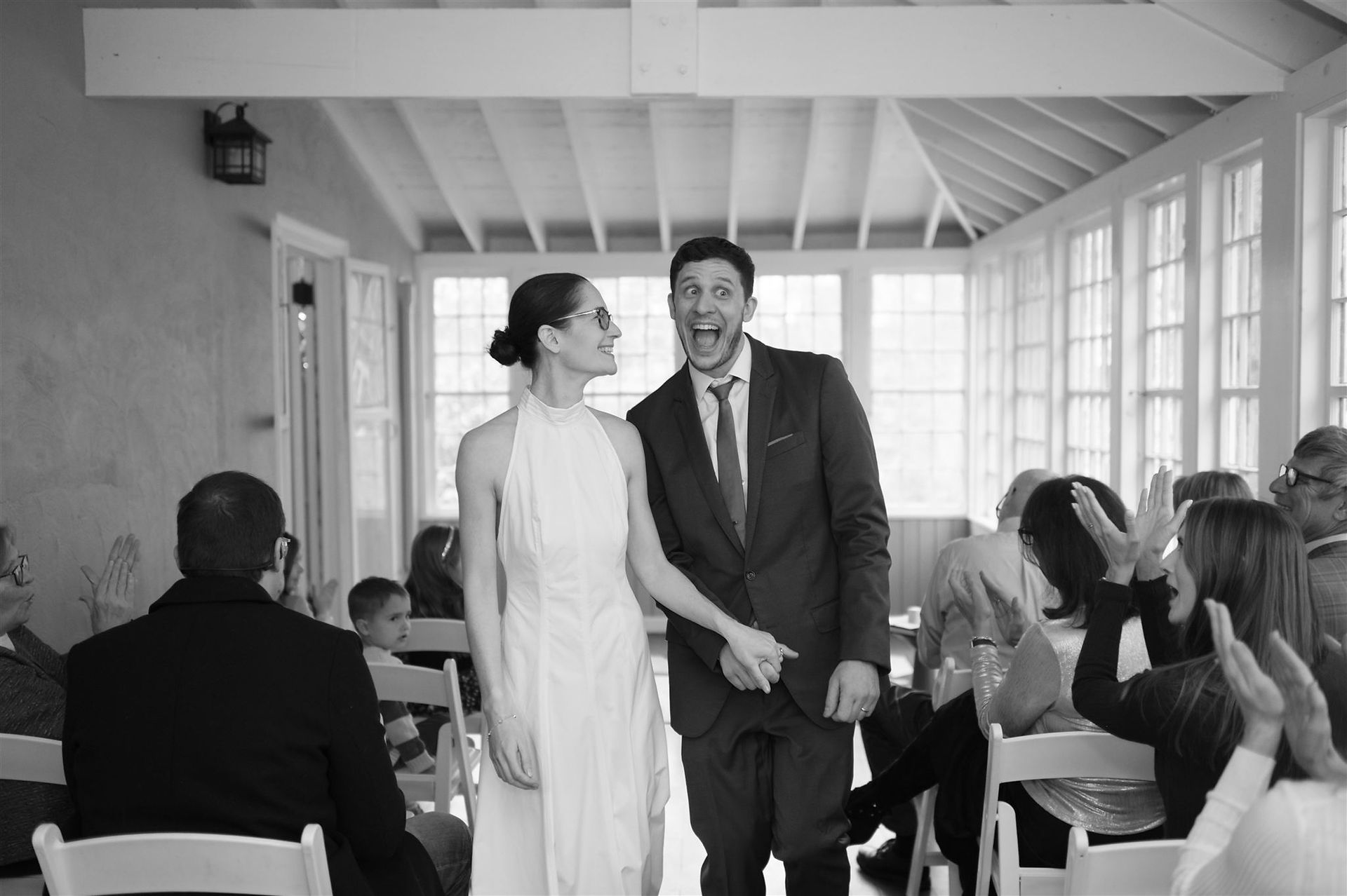 couple leaving wedding ceremony smiling