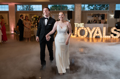 couple's first dance with big light up letters in background