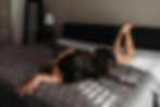 boudoir session on bed with direct shadow window light