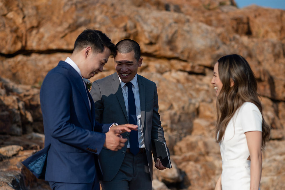 groom looking at his ring after wedding ceremony