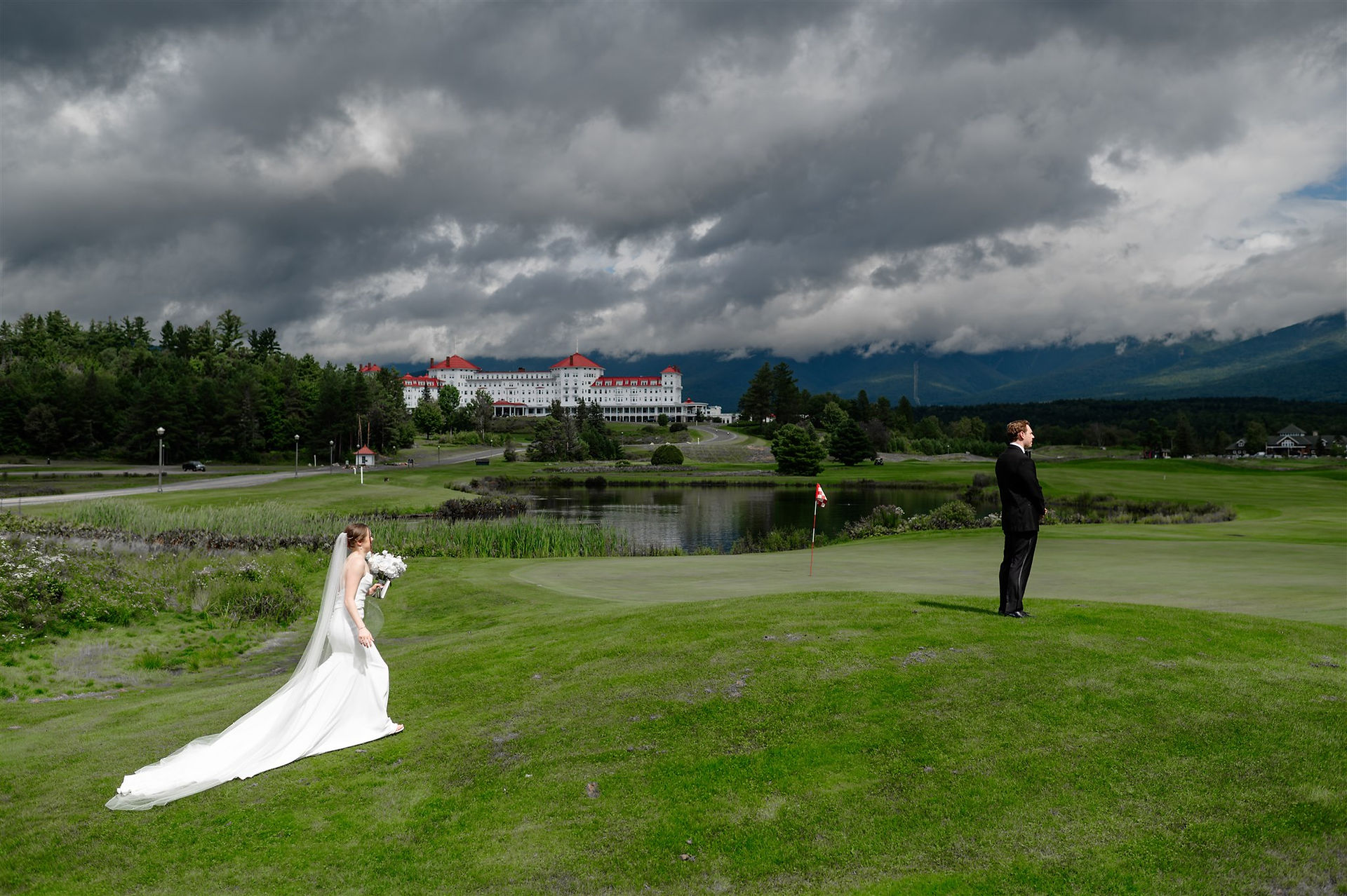 bride approaching groom for first look with omni mount Washinginton in the background
