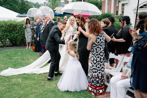 bride high-fiving flower girl during recessional