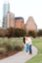 doug sahm hill downtown austin proposal. couple in a pose kissing in front of the Austin skyline for their engagement session right after she says yes!