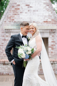 couple laughing on roof of inn on boltwood with fireplace as backdrop