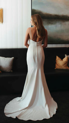 A wedding dress with spaghetti straps and V-neck.