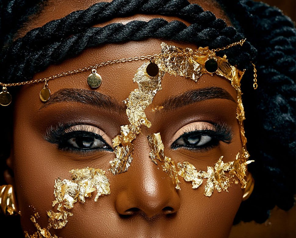A close up on a woman's face with a gold-mask shaped makeup look