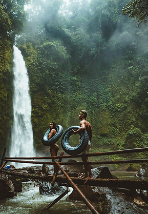 Couple looks on in wonder at a Waterfall
