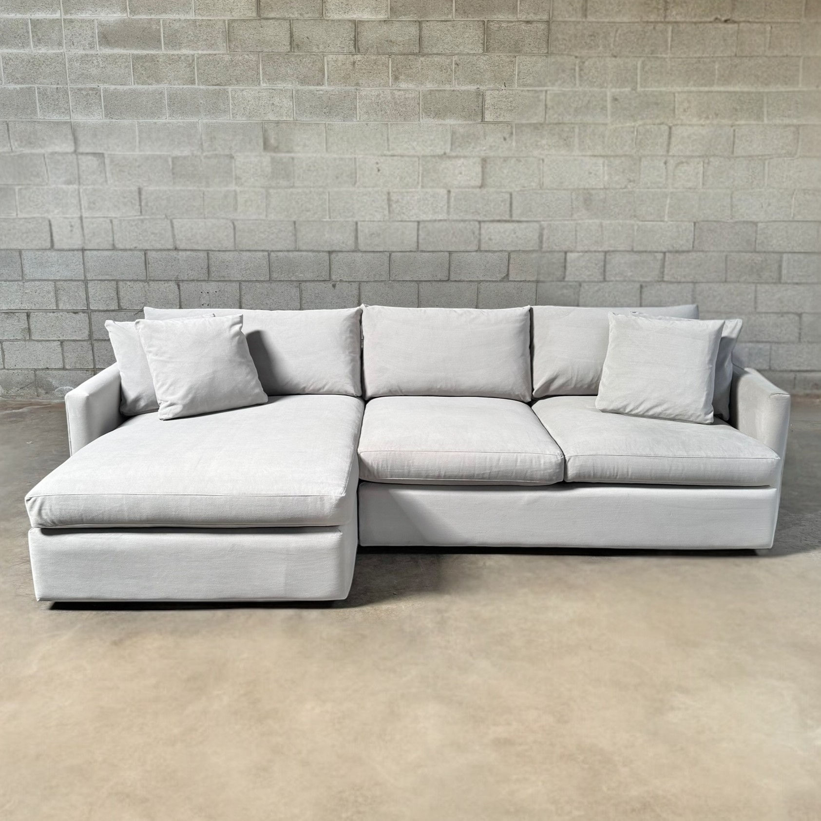 multiple couches and sofa in brown, gray, white