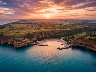 This breathtaking drone shot captures the sunrise over Bolata Bay, a stunning beach on th