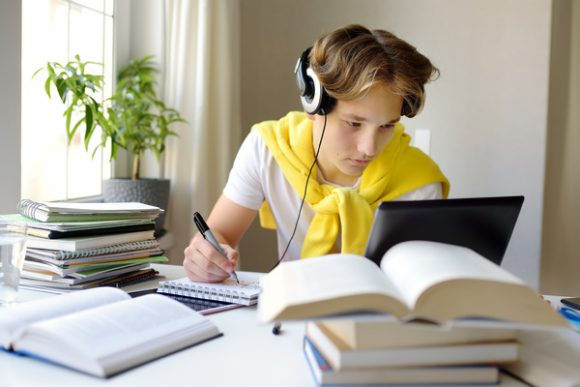 teen-wearing-headphones-in-front-of-a-computer.jpeg