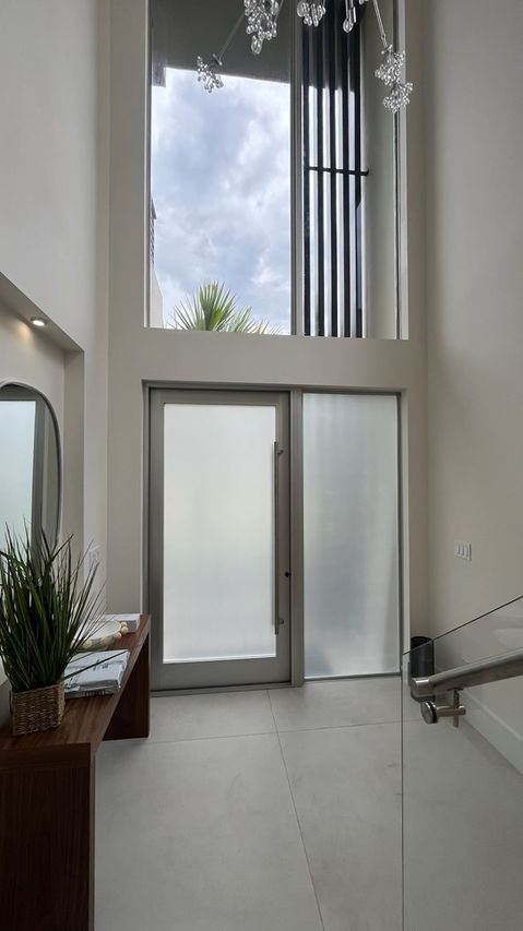 Expert installation of frosted film on a front door glass panel, delivering a clean, modern finish with enhanced privacy and natural light balance. AWT American Window Tinting, Delray Beach.